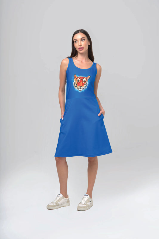 Woman wearing a blue dress with a tiger design on a gray background